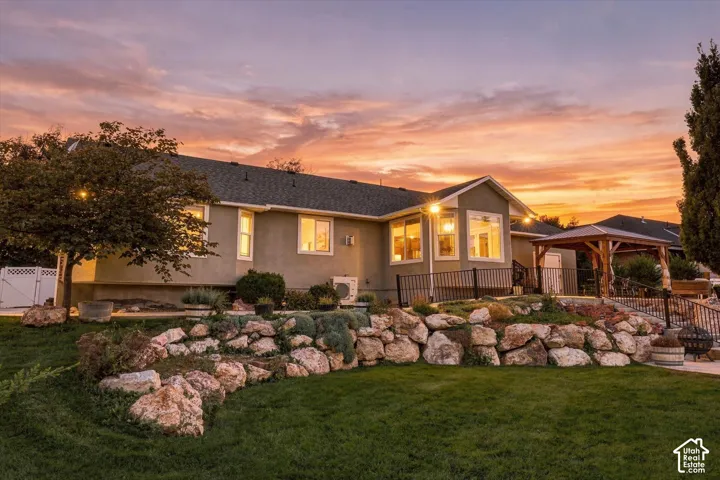 Expansive lawn with a rock retaining wall and integrated landscaping