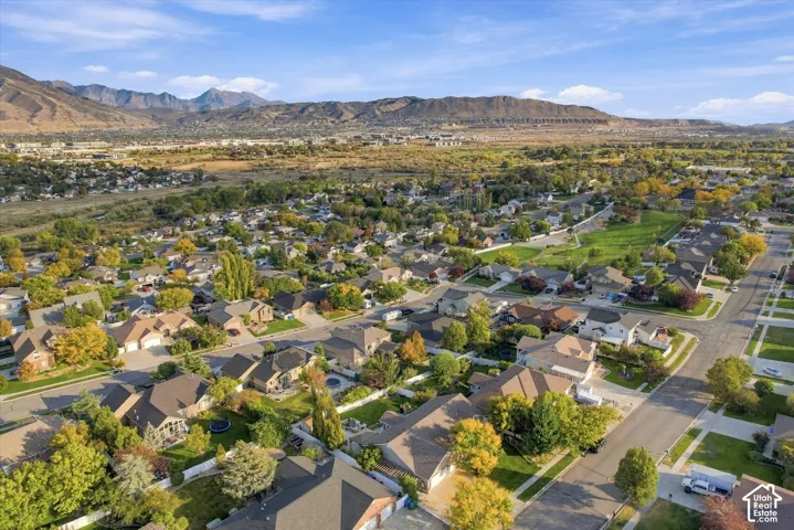 Aerial view showcasing a well-established residential community nestled against dramatic mountain backdrop