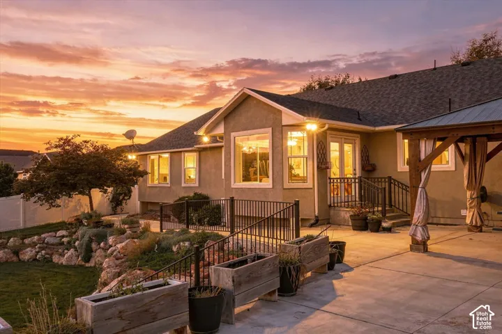Expansive concrete patio with a built-in pergola featuring a metal roof