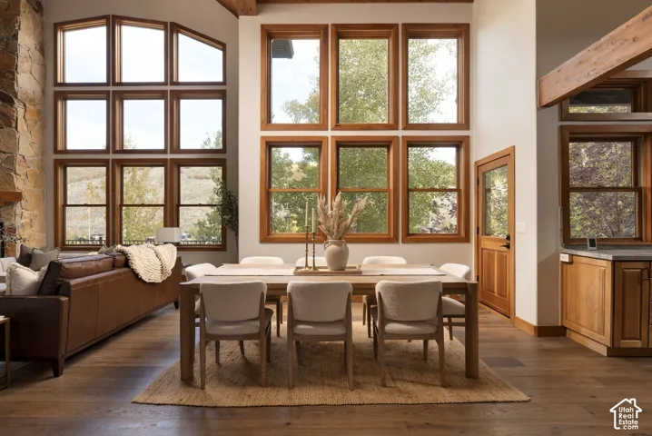 Sophisticated dining space anchored by abundant natural light from multiple multi-pane wood-frame windows