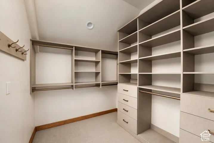 Custom closet organization system featuring multiple shelves, hanging rods, and integrated drawers