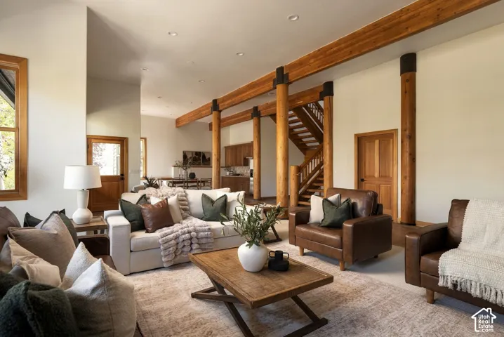 Exposed wood beams and columns, wood-framed windows, recessed lighting, wood staircase, and wood interior doors