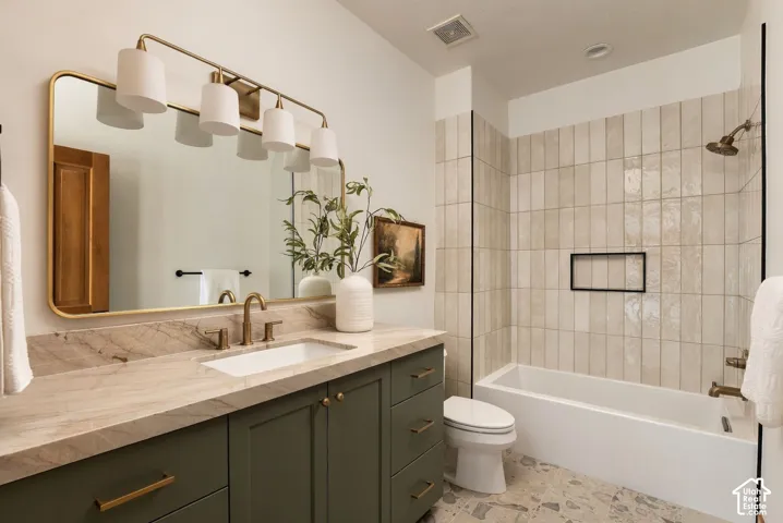 Single vanity with stone countertop, integrated sink, and bronze faucet