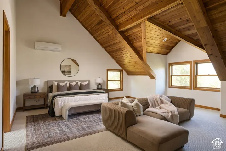 Vaulted wood-paneled ceiling with exposed beams, multiple windows, and light-colored wall finishes