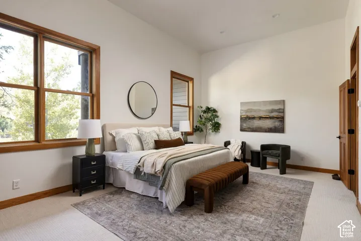 Expansive room featuring light-colored carpeting, white wall finishes, and recessed lighting
