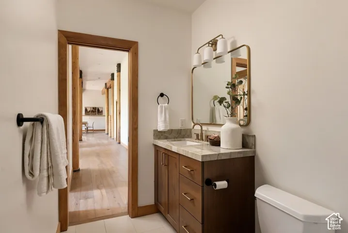 Wood-finish vanity with a stone countertop and an undermount sink