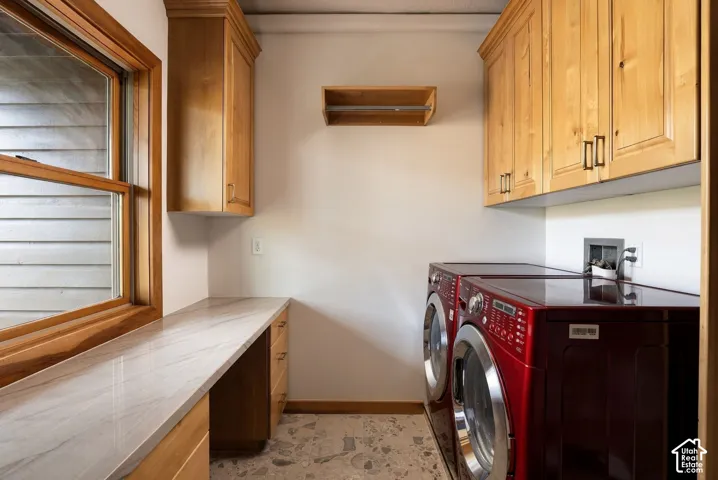 Wood-frame window, light wood cabinetry, stone-finish countertop, and durable flooring