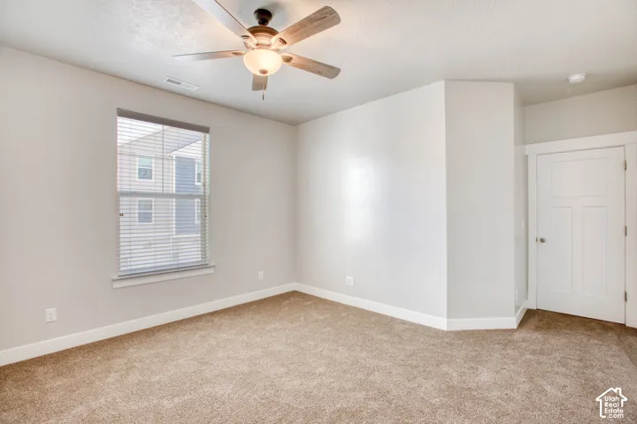 Soft tan carpeting with a neutral wall color and white trim