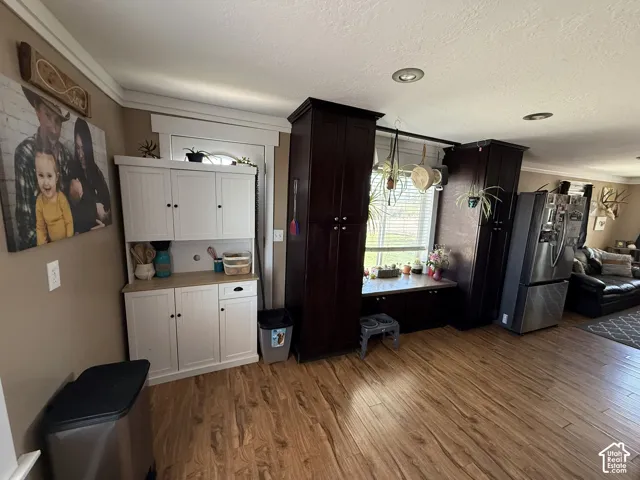 Wood-finish flooring, recessed lighting, and a window with blinds