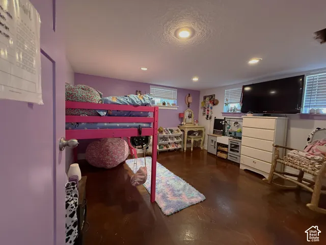 Recessed lighting illuminates the wood-finish flooring