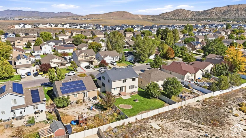 Suburban neighborhood setting with established homes, mature landscaping, and mountain backdrop
