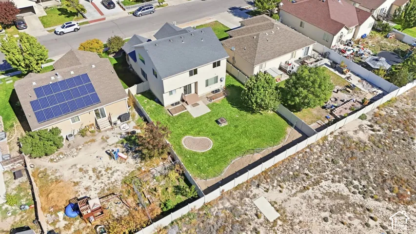 Modern residence with expansive manicured lawn, mature landscaping, and defined property boundaries