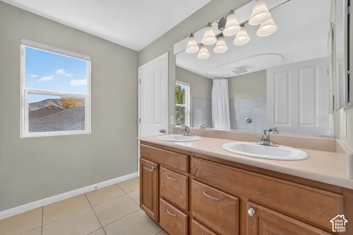 Dual basin vanity with wood-finish cabinetry and chrome hardware