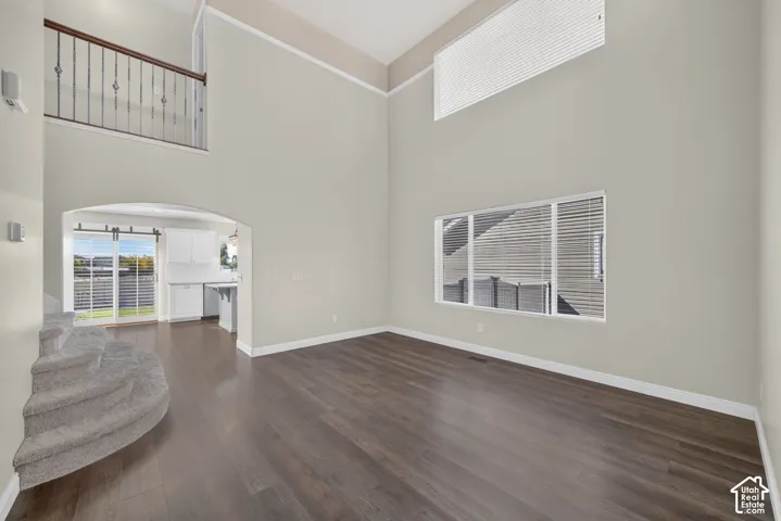 Vaulted ceilings, wood-finish flooring, and an arched doorway