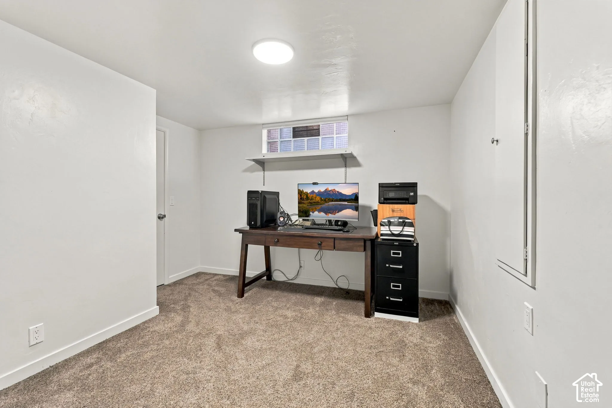 Finished basement office featuring neutral carpet flooring, recessed ceiling lighting, and ample wall space