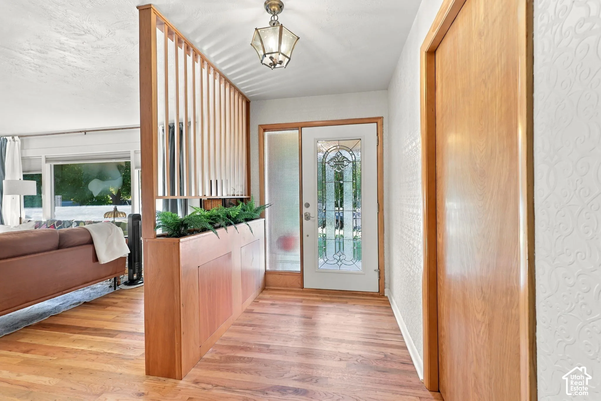 Wood-finish flooring with a decorative room divider and built-in planter
