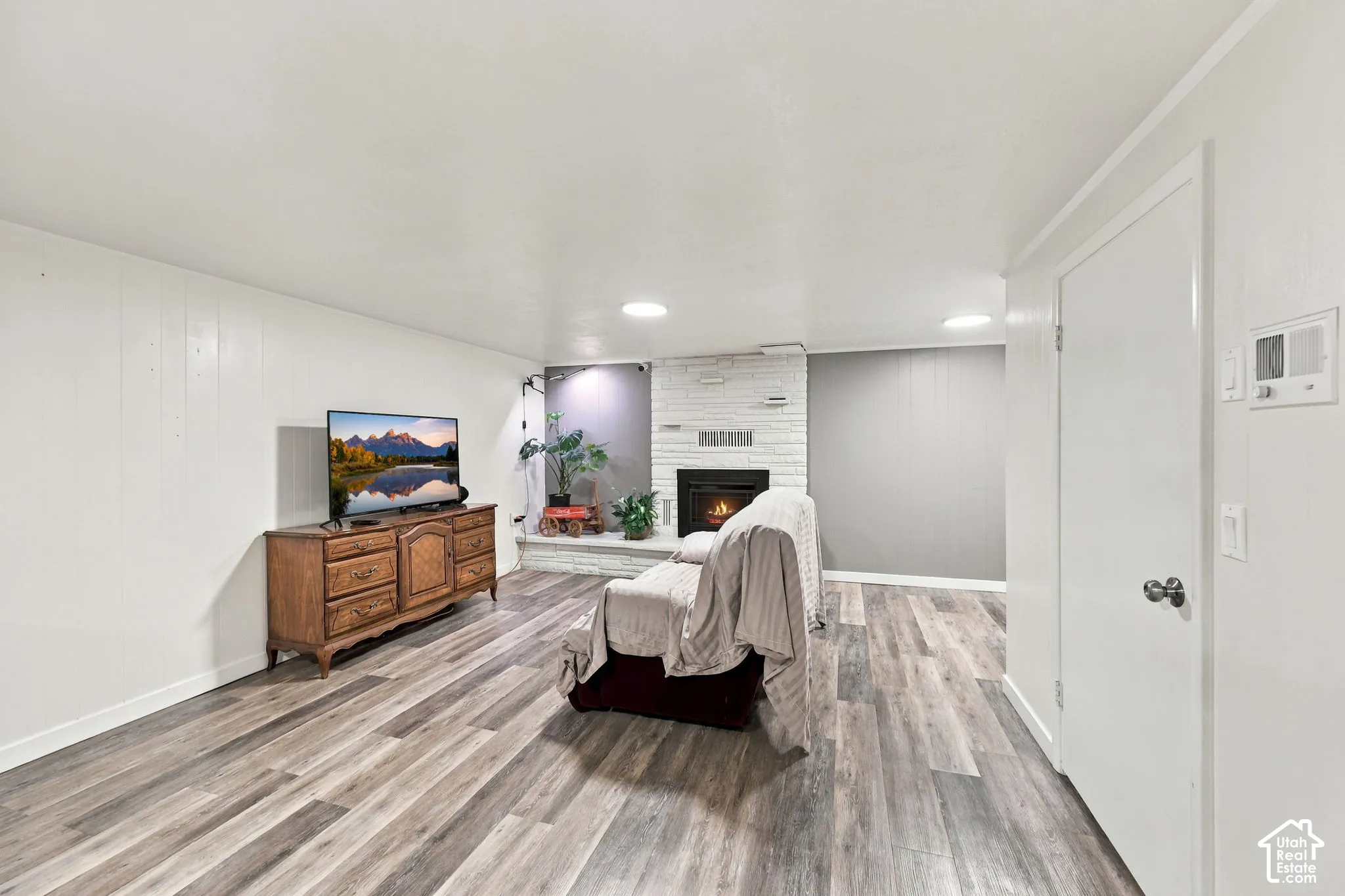 Wood-finish flooring with white wall paneling