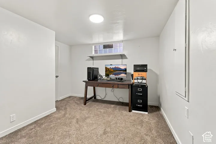 Finished basement office featuring neutral carpet flooring, recessed ceiling lighting, and ample wall space