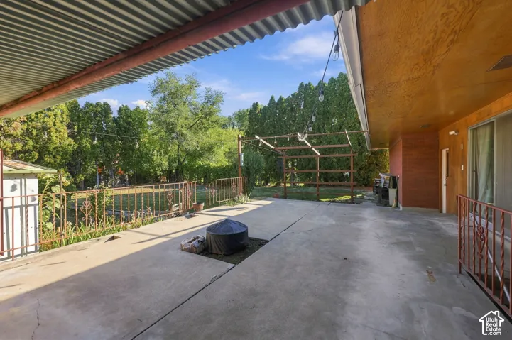 Expansive concrete patio with a corrugated metal overhang