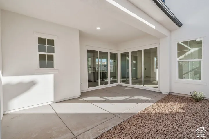 Covered patio with concrete flooring, recessed lighting, and large sliding glass doors