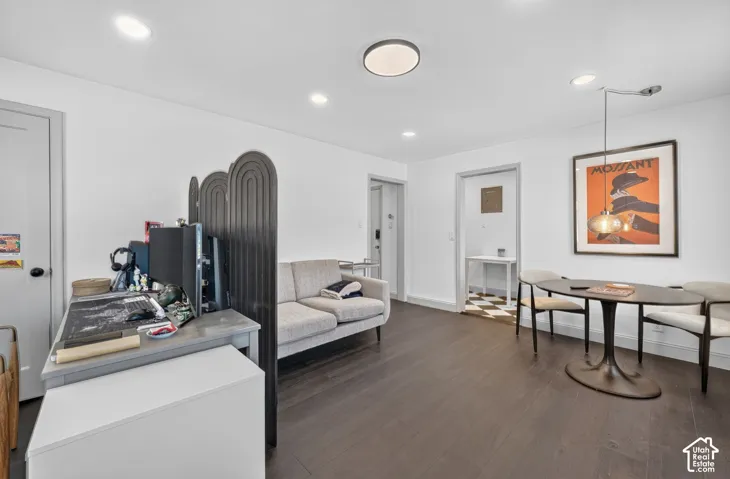 Recessed lighting illuminating dark wood-finish flooring