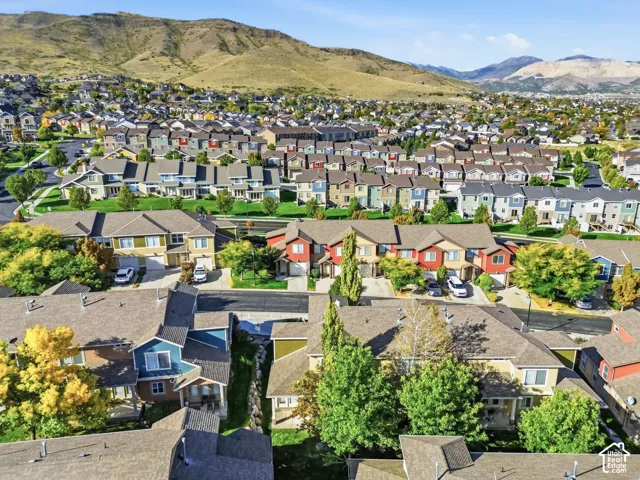 Residential community with varied architectural styles and mature landscaping, framed by distant mountains