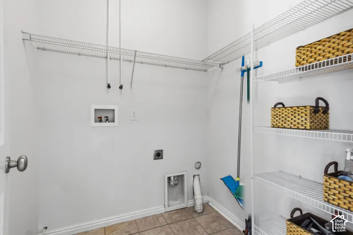 White wire shelving, tile flooring, and utility hookups