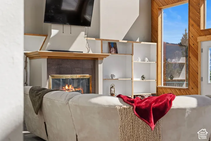 Fireplace with stone surround and wood mantel