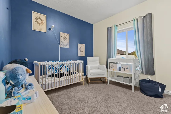 Carpeted flooring, white trim, and a window with white framing