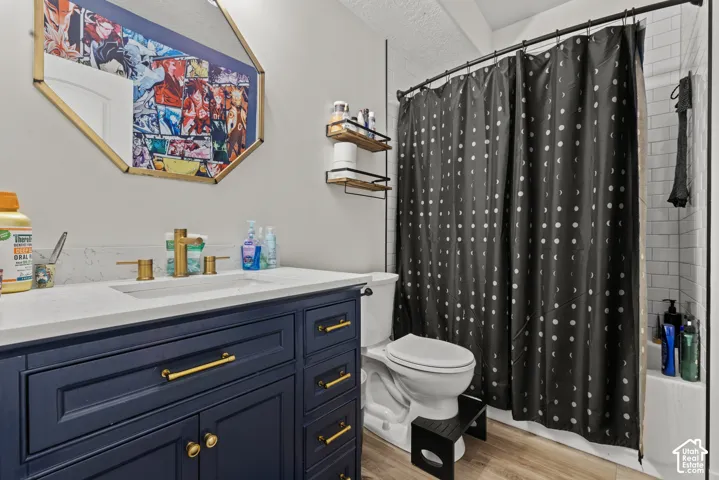 Navy blue vanity with gold-tone hardware, white countertop, and gold-tone faucet