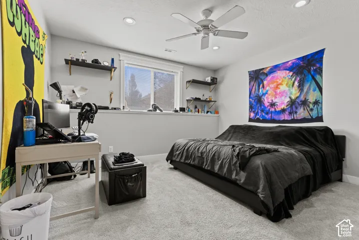 Recessed lighting, ceiling fan, carpeted flooring, and a large window