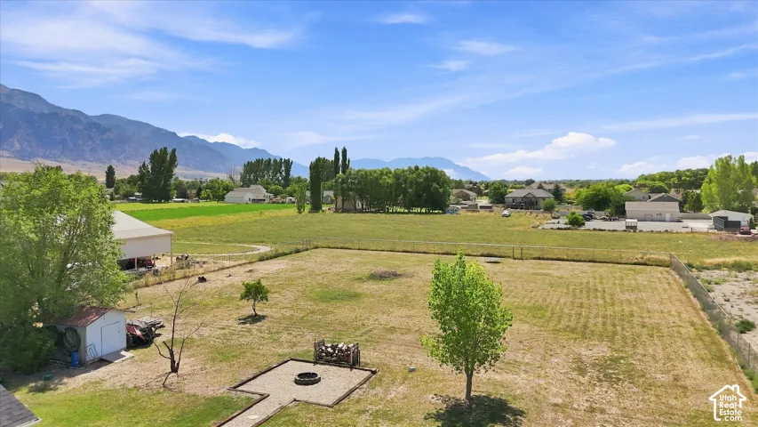 Expansive grounds featuring mature landscaping, manicured lawn areas, and scenic mountain backdrop