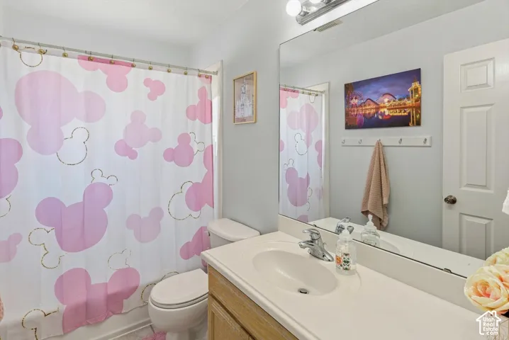 White bathroom vanity with an integrated sink and chrome faucet