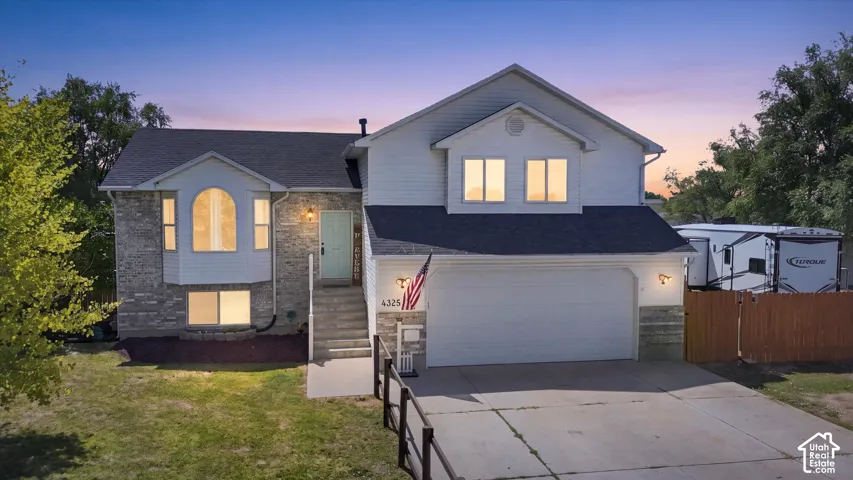 Modern two-story residence featuring a brick and stone exterior with a two-car attached garage