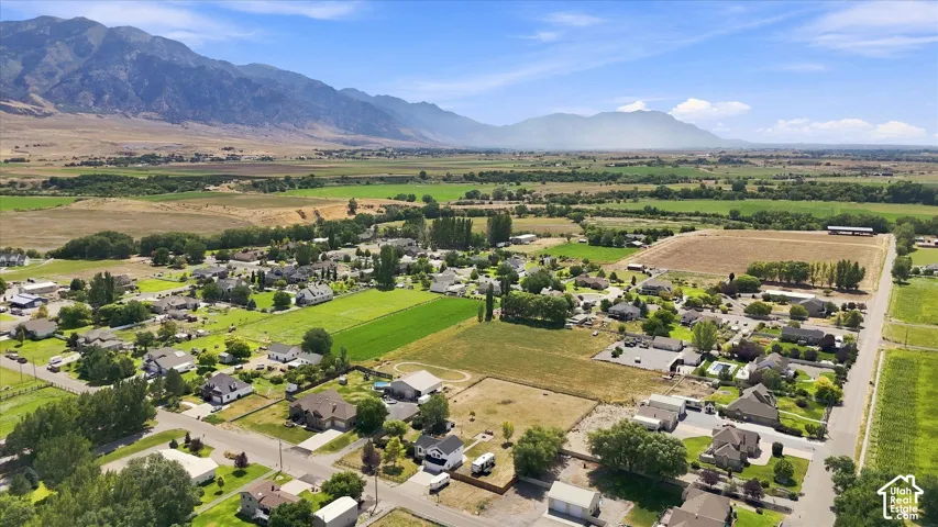 Expansive mountain range backdrop and surrounding rural landscape