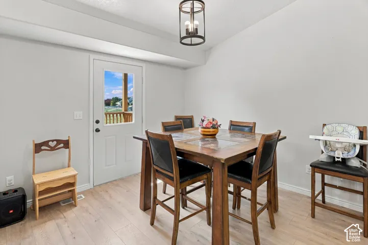 Light wood-finish flooring with white walls