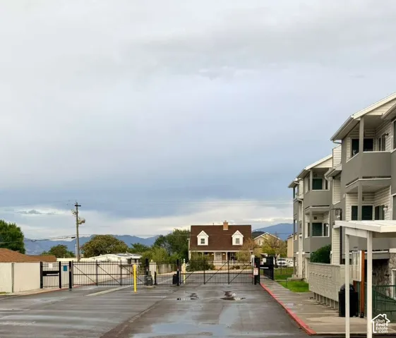 Multi-story building exterior with balconies and a covered walkway