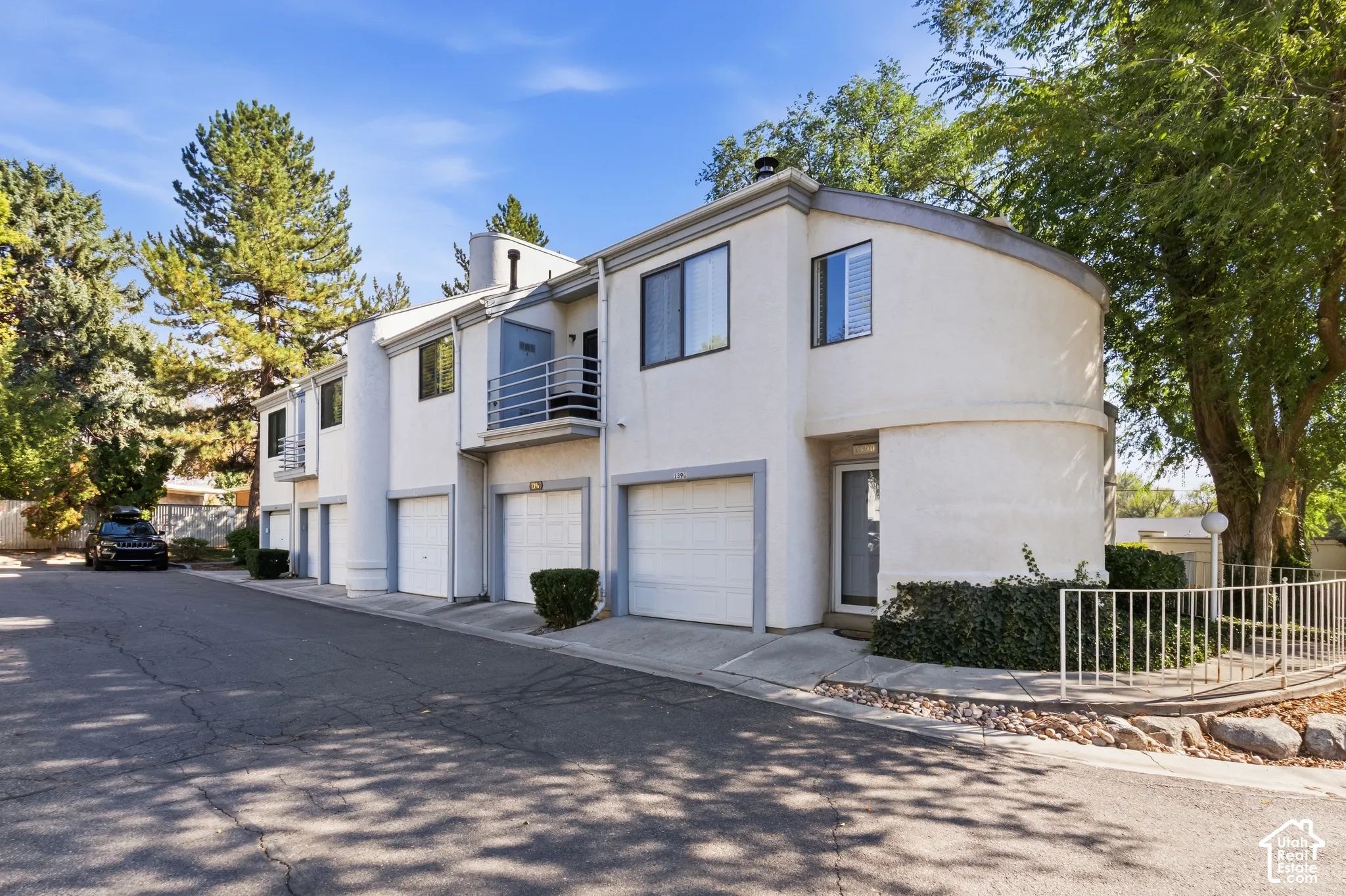 Multi-level stucco exterior with individual garages