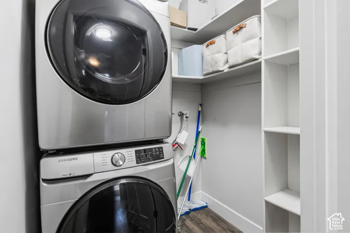 Stackable washer and dryer unit, built-in shelving, wood-finish flooring