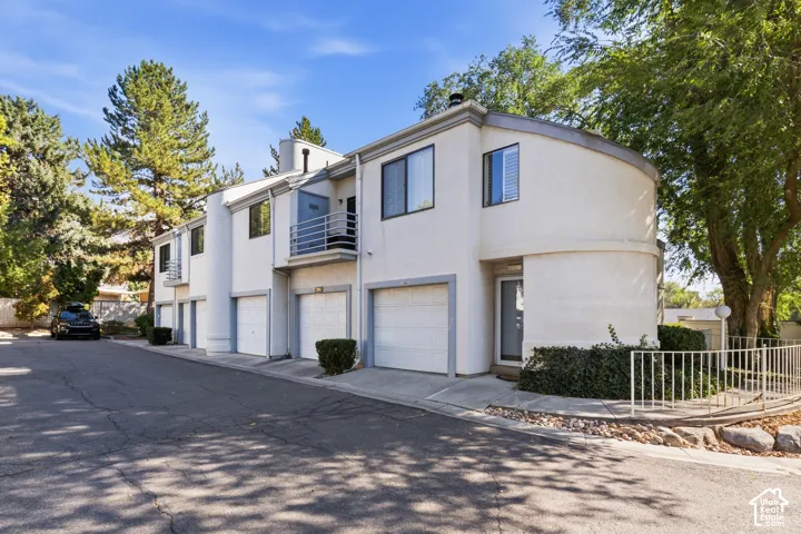 Multi-level stucco exterior with individual garages
