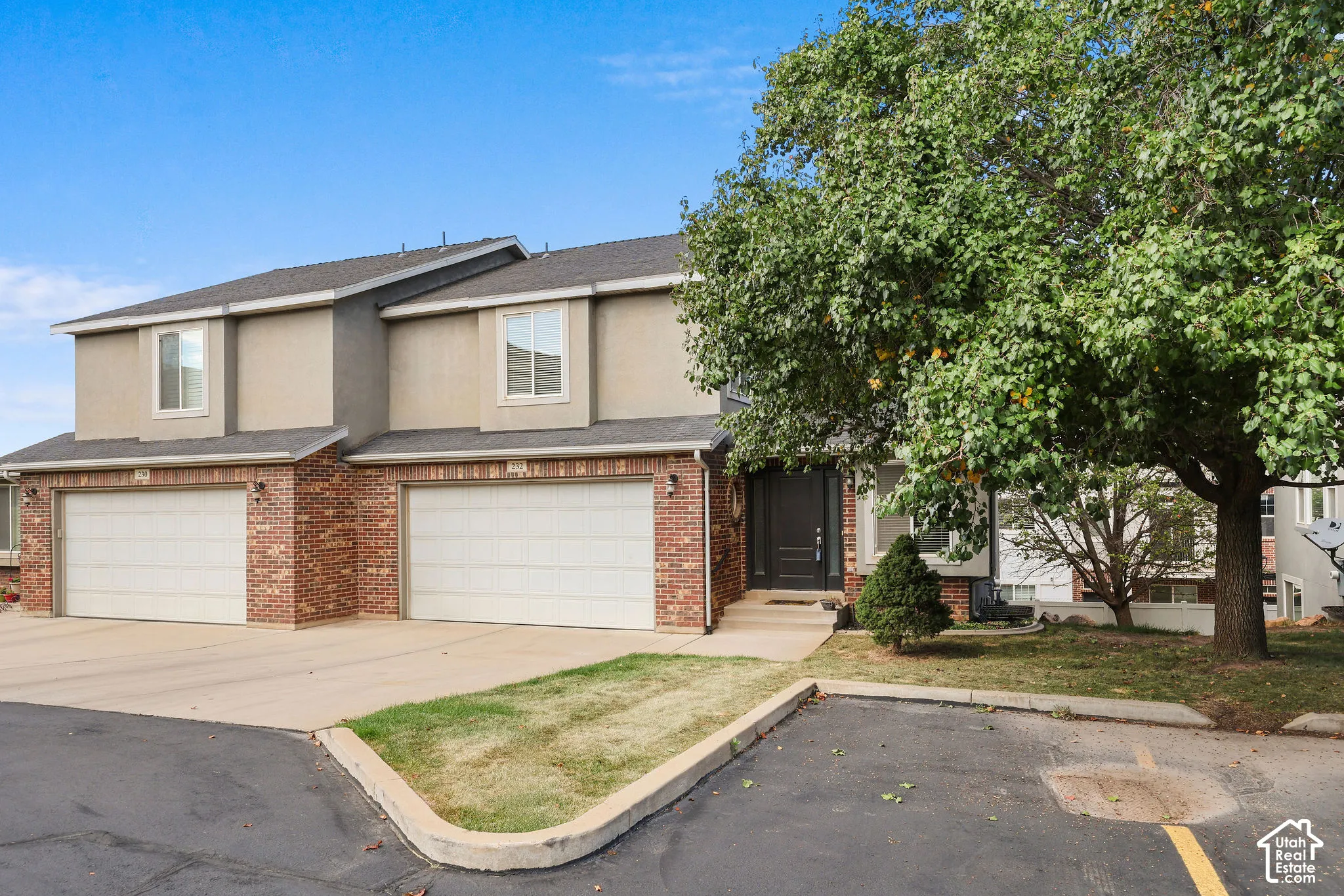 Two-story exterior with a mix of brick and stucco siding