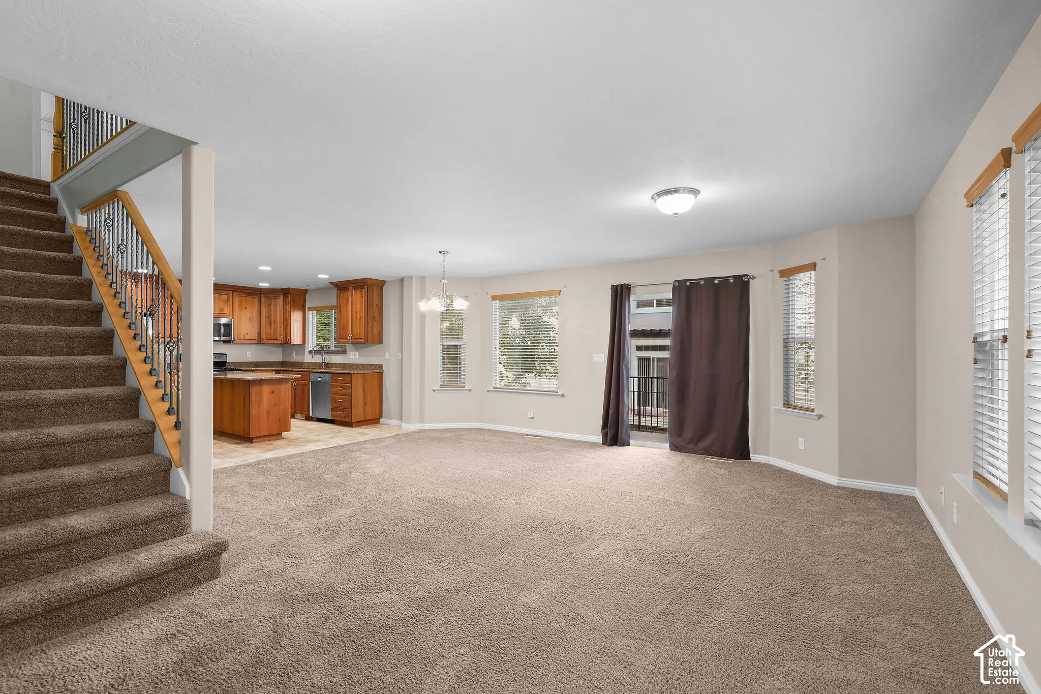 Open concept living space with carpeted flooring