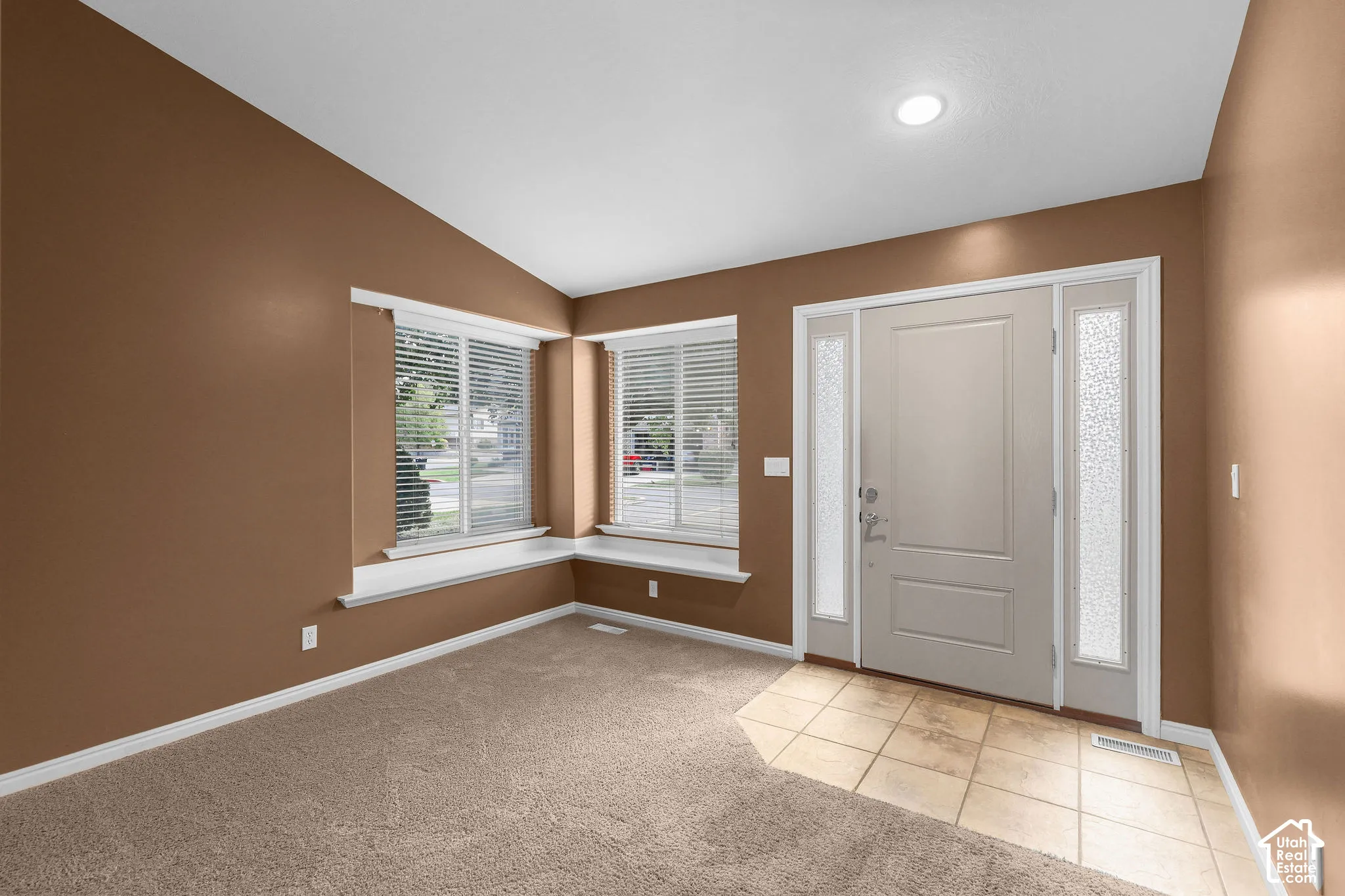 Entryway featuring a paneled door with frosted glass sidelights, recessed lighting, and tile flooring