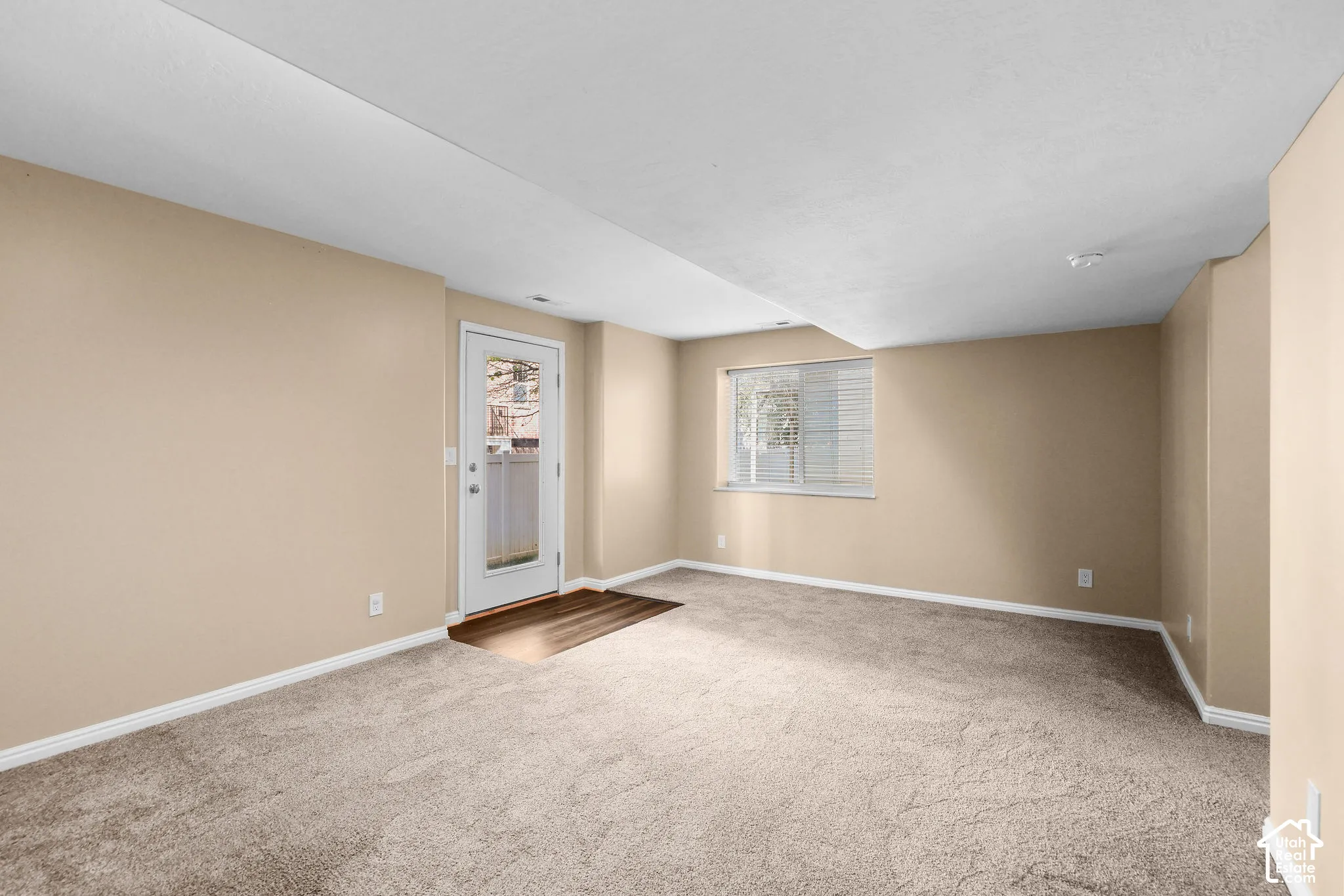 Neutral-toned walls and plush carpet flooring