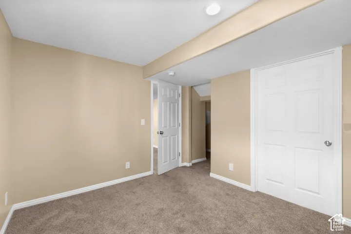 Plush carpet flooring, neutral paint palette, recessed ceiling lighting, white interior doors, and white trim