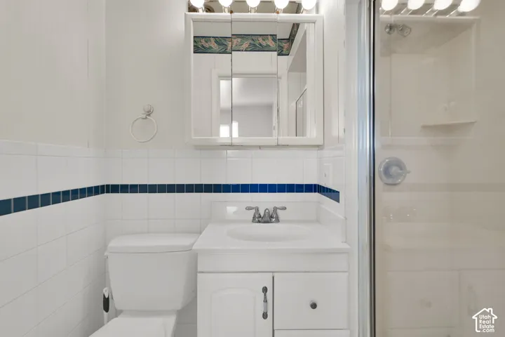 White tiled walls with a blue accent band