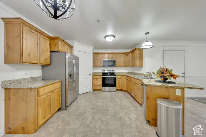 Kitchen featuring wood cabinetry, granite-style countertops, stainless steel appliances, and a built-in dishwasher
