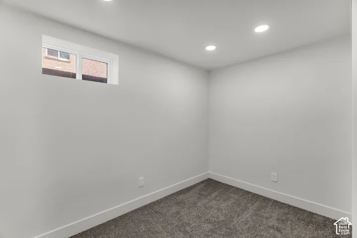 Recessed lighting, light gray wall paint, white trim, and gray carpet