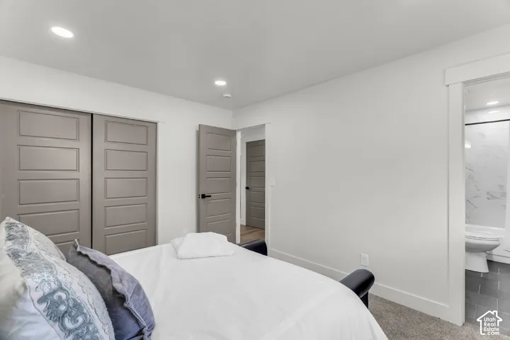 Recessed lighting throughout, gray paneled doors, and white trim