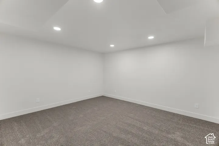 Recessed lighting, light gray carpet, and white walls